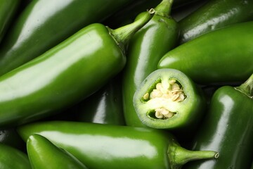 Fresh green jalapeno peppers as background, closeup
