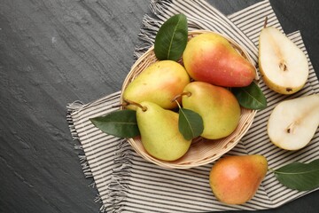Many fresh pears and leaves on black table, flat lay. Space for text