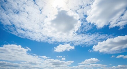 A vast expanse of a vibrant blue sky dotted with puffy white clouds