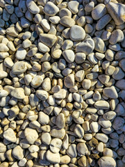 Close up view of white river stones with natural light and shadow