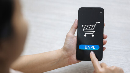 BNPL button on smartphone, finger tapping to confirm Buy Now Pay Later mobile checkout