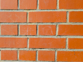 Red brick wall with horizontal mortar pattern closeup