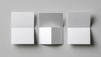 Three blank folded brochures on a gray background