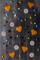 Various sweet food on black chalkboard background. Flat lay. Top view. Food concept.