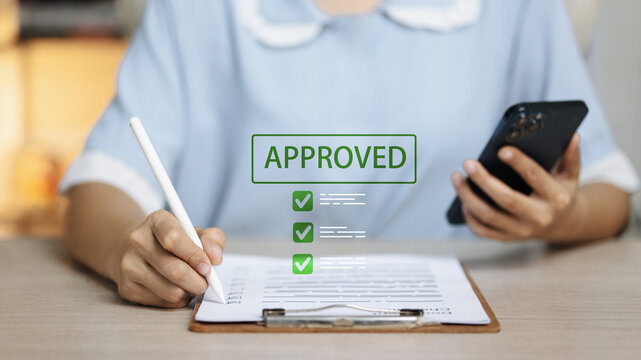 Approved loan application with checklist, smartphone and stylus, digital lending