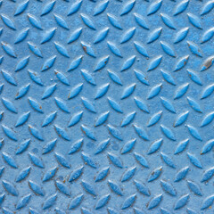 Blue painted diamond plate steel surface with raised tread pattern, showing some scratches and worn texture. Industrial metal background