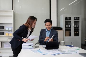 Business team discusses startup strategy with investor using tablet, laptop, and smartphone.