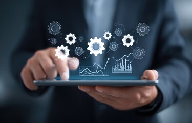 Businessperson holding tablet with digital gears and graphs
