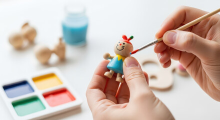 Crafting wooden toy figure with colorful paints and brushes in hands. Painting activity includes vibrant colors, playful designs, and attention to detail.