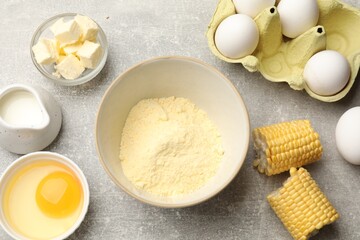 Cornbread preparation. Different ingredients on light grey table, flat lay