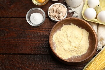 Cornbread preparation. Different ingredients on wooden table, flat lay. Space for text