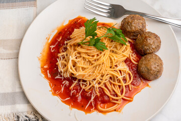spaghetti top with parsley and meat balls