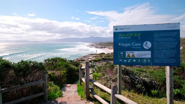 Path to Klipgat Cave in Walker Bay Nature Reserve with tourist information board
