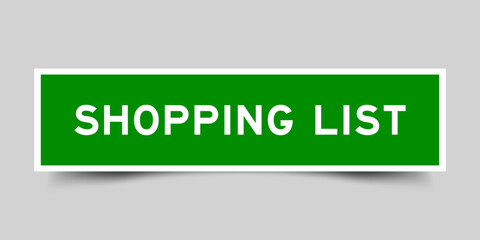 Green color square shape sticker label with word shopping list on gray background
