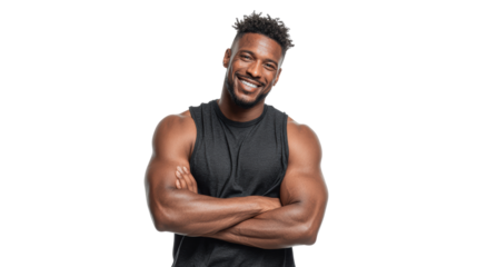 Smiling young man with muscular arms, wearing a sleeveless shirt, standing confidently with crossed arms.