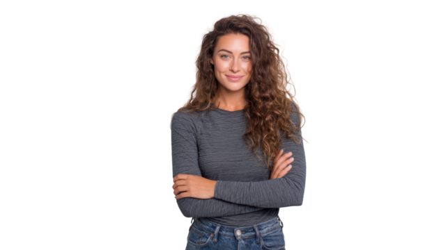 Confident young woman with curly hair smiling, standing with arms crossed, isolated on white background.