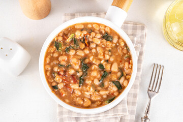 One pot Marry Me Butter Beans with white beans, Sun-Dried Tomatoes, spinach, garlic, hard cream and seasonings, fall season american comfort food, vegan healthy dinner rich in plant-based protein