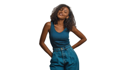 Smiling woman in casual outfit, hands on hips, standing confidently against a white background.