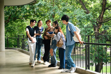 Obraz premium Group of University Students Discussing and Sharing Ideas Outside Campus Building