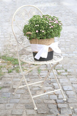 Bouquet of flowers on a chair on the street