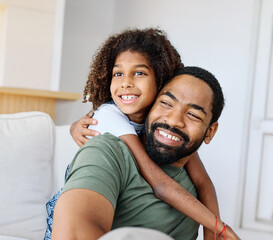 Obraz premium Portrait of a happy black family father and kid girl daughter having fun bonding at home