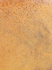 Close-up of rusty metal surface with textured orange and brown corrosion