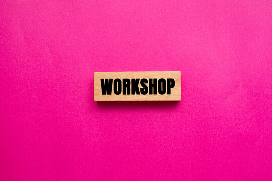 Workshop message written on wooden block on pink background. Conceptual Workshop symbol. Copy space. - Powered by Adobe