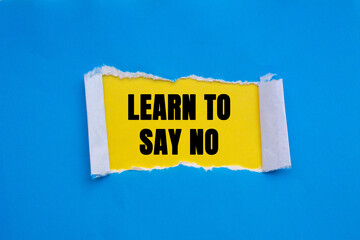 Learn to Say No message written on ripped torn blue paper on yellow background. Conceptual Learn to...