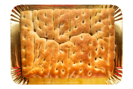 Focaccia bread ligurian tipical of Genova - flatbread of sourdough and olive oil on a golden tray isolated on white with clipping path included