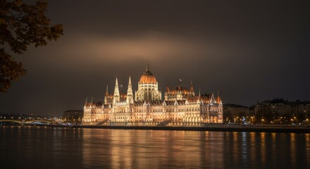 Fototapeta premium Illuminated historical building by night reflecting on water