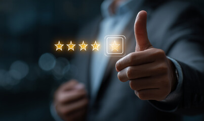 A satisfied customer gives a thumbs up for a five-star rating on his mobile phone, showing his positive feedback. Customer review satisfaction feedback survey concept. 