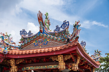 Traditional Chinese temple roof with ornate carvings and golden details in George Town, Penang, Malaysia