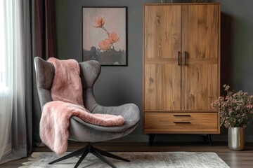 Grey lounge chair with pink fur blanket near wooden wardrobe against grey wall. Scandinavian, farmhouse home interior design of modern living room, Generative AI