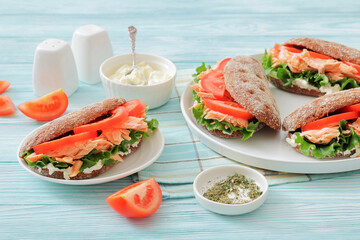rye bread sandwiches with grilled salmon, veggies