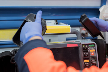 Close up view of a doctor using defibrillator in an ambulance. High quality photo