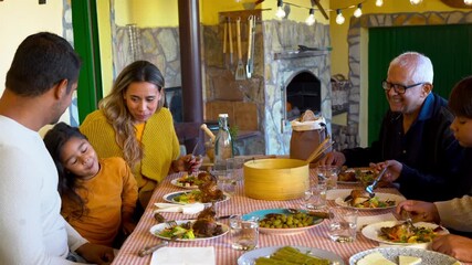 Happy multi generational latin family enjoy lunch outdoor at house terrace - Grandparents, parents and children - Fall season - Powered by Adobe
