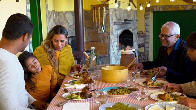 Happy multi generational latin family enjoy lunch outdoor at house terrace - Grandparents, parents and children - Fall season