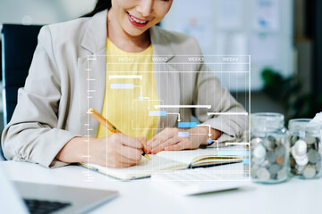 Asian businesswoman using tablet with financial analytics overlay. Concept of fintech, investment, data visualization, smart finance, and digital economy.
