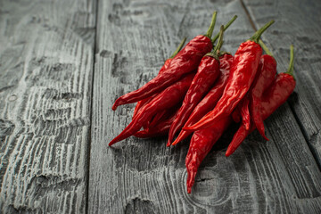 Fresh Red Chili Peppers on Rustic Wooden Background - Spicy Ingredient in Modern Culinary Art