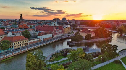 Golden Hour Aerial View of Ostrów Tumski in Wrocław with Gothic Cathedral, Tumski Bridge and Historic Architecture by the Oder River, Poland
