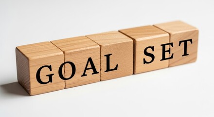 Goal Set Wooden Blocks - Wooden blocks spelling "GOAL SET" on a white background. Great for concepts like achievement