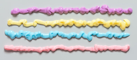 Samples of colored cream stripes on a gray background