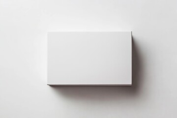 Minimalist white rectangular box on white surface. AI generated
