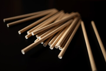 Sticks lying on a dark surface for cooking or crafting activities during a creative evening