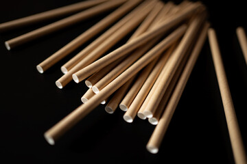 Wooden sticks scattered on a dark surface create an artistic still life scene for creative inspiration