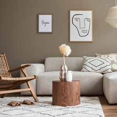 Stylish interior with design neutral modular sofa, mock up poster frames, rattan armchair, coffee tables, dried flowers in vase, decoration and elegant personal accessories in modern home decor.