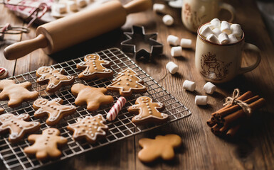 Christmas Baking Scene Featuring Decorated Gingerbread Men, Star and Tree Cookies, Candy Canes, Marshmallows, and Holiday Tools, Festive Culinary Setup with Rolling Pin, Whisk, Cookie Cutter.