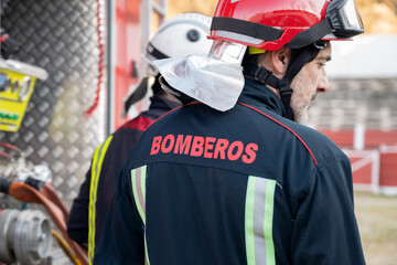 Firefighter check and maintenance equipment near fire truck. High quality photography