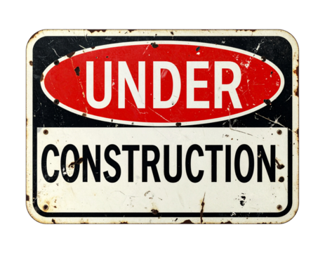 A weathered sign indicating construction work is in progress, featuring bold red and black lettering.