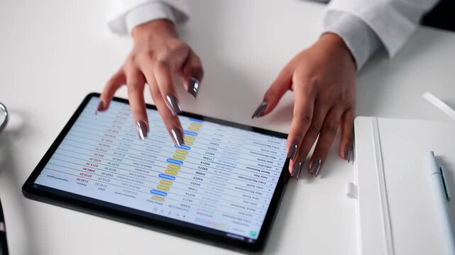 Woman In Hospital Using Tablet For Medical Billing - Powered by Adobe